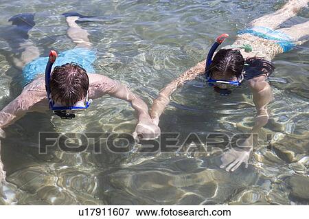 A couple snorkeling together View Large Photo Image Stock Photo - A couple snorkeling together. Fotosearch