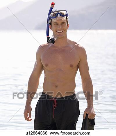 Stock Photo - A man snorkeling in the sea. Fotosearch