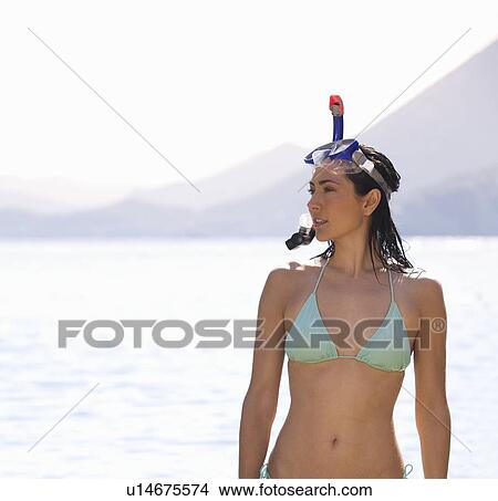 Picture - A woman snorkeling in the sea. Fotosearch