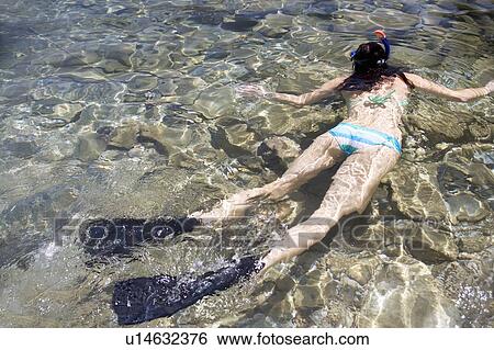 Stock Photograph - A woman snorkeling. Fotosearch