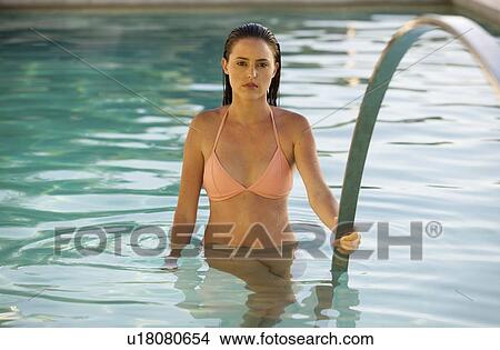 A young woman in a swimming pool View Large Photo Image Picture - A young woman in a swimming pool. Fotosearch