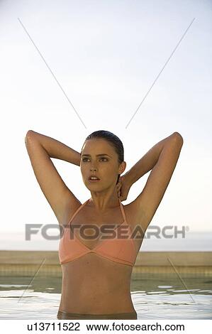 Stock Image - A young woman in a swimming pool. Fotosearch