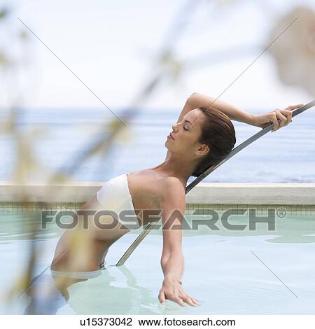 Stock Image - A young woman in a swimming pool. Fotosearch