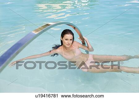 Stock Image - A young woman in a swimming pool. Fotosearch
