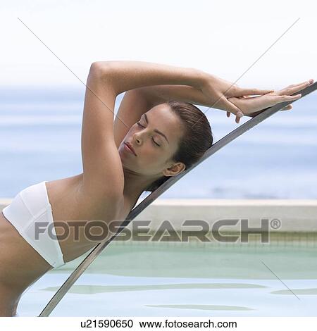 Stock Image - A young woman in a swimming pool. Fotosearch