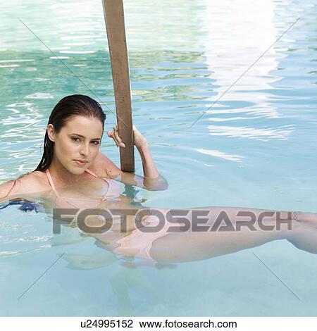 A young woman in a swimming pool View Large Photo Image Stock Image - A young woman in a swimming pool. Fotosearch