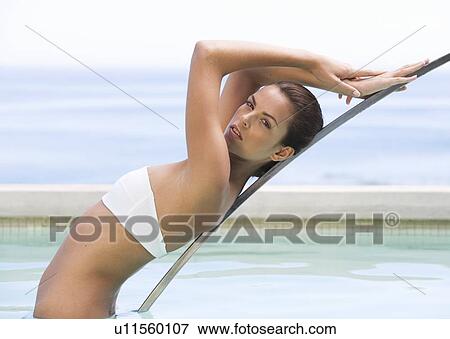 Stock Photo - A young woman in a swimming pool. Fotosearch