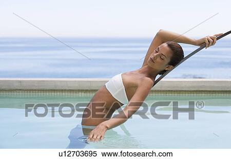 A young woman in a swimming pool View Large Photo Image Stock Photography - A young woman in a swimming pool. Fotosearch