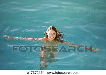 A young woman swimming in a pool View Large Photo Image Picture - A young woman swimming in a pool. Fotosearch