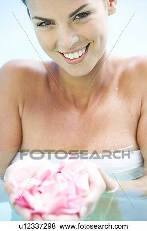 Stock Photo - Portrait of a young woman in a swimming pool. Fotosearch