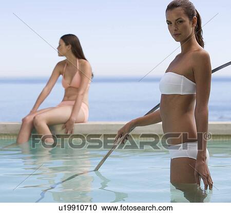 Two young women in a swimming pool View Large Photo Image Stock Image - Two young women in a swimming pool. Fotosearch