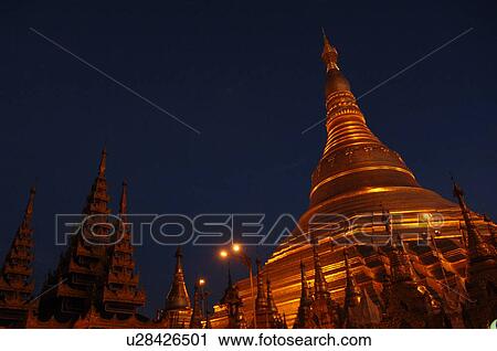 Stock Image - Golden Stupa at night. Fotosearch