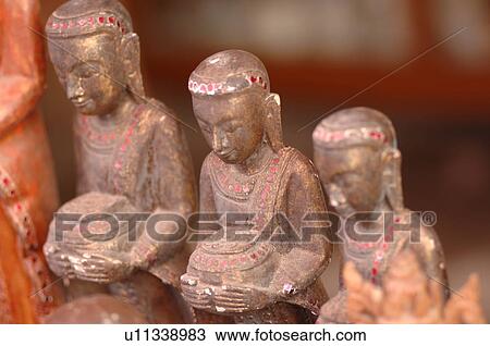 Stock Image - Statues on display in marketplace. Fotosearch