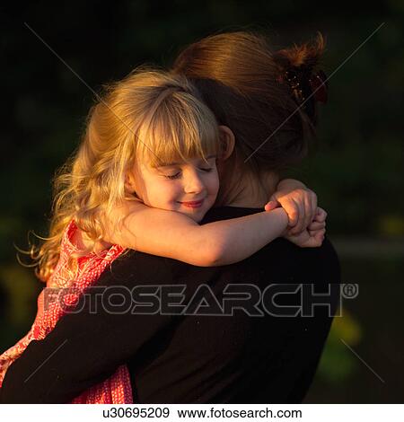 Stock Photo - 4 year old embracing her Mother's neck. Fotosearch