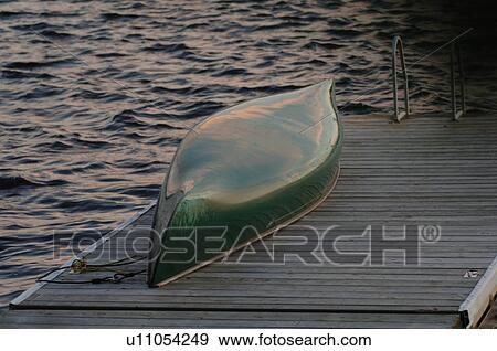 Canoe upside down on dock View Large Photo Image Stock Photo - Canoe upside down on dock. Fotosearch