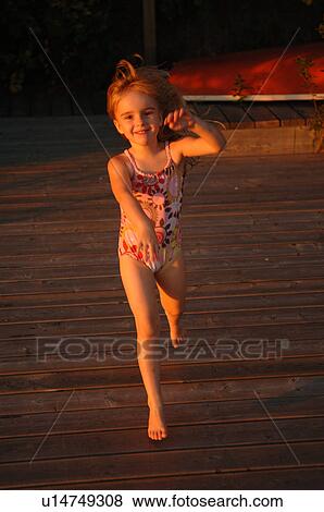 Child running on a wooden pier View Large Photo Image Stock Photo - Child running on a wooden pier. Fotosearch