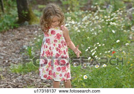 Stock Photo - Girl picking wildflowers. Fotosearch