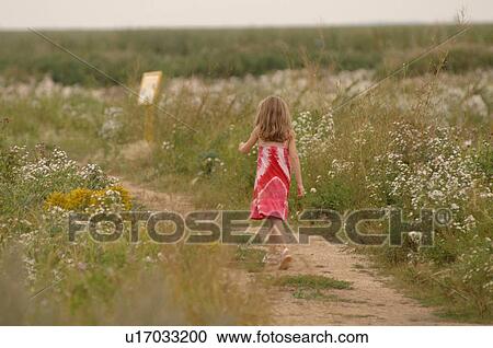 Stock Image - Girl walking on Path. Fotosearch