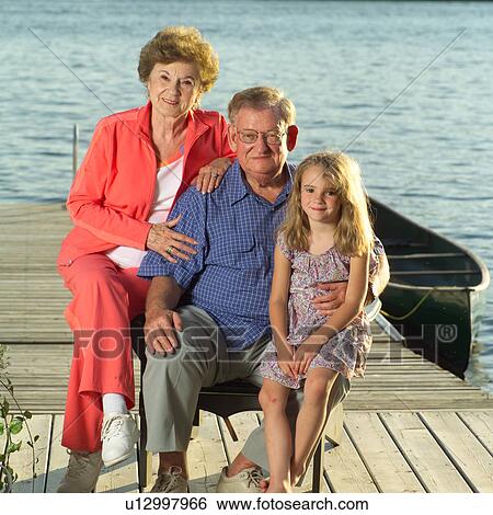 Grandparents posing with grandchild View Large Photo Image Stock Photograph - Grandparents posing with grandchild. Fotosearch