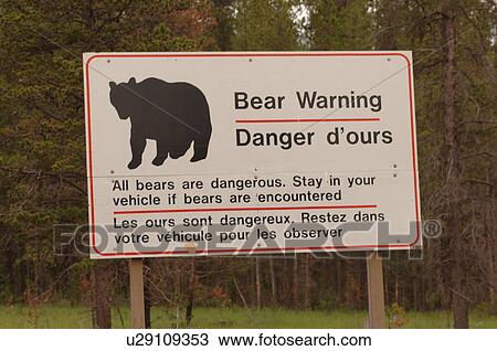 Stock Image - Picture of bear on warning sign, Jasper National Park, Canada. Fotosearch