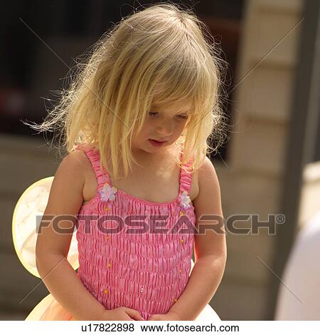 Stock Photo - Young girl in a fairy costume standing outdoors. Fotosearch