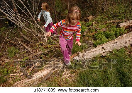 Stock Photo - Young girls hiking in forest. Fotosearch