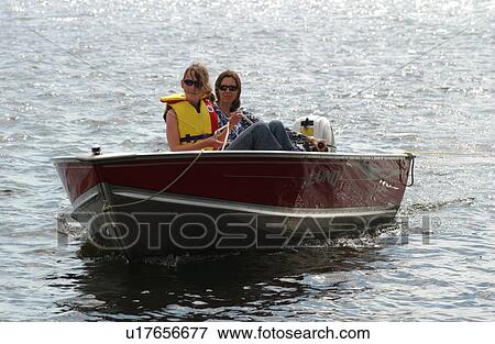 Young woman and her daughter in a motor boat View Large Photo Image Stock Photo - Young woman and her daughter in a motor boat. Fotosearch