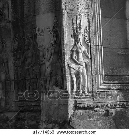 Stock Image - Carved Figurines on Walls of Khmer Kingdom palace ruins. Fotosearch