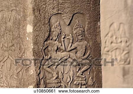 Stock Image - Carving on wall of Khmer Kingdom palace ruins. Fotosearch