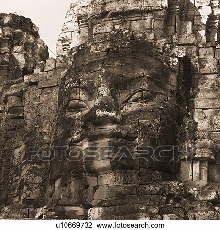 Stock Image - Large Buddha statue at the Khmer Kingdom palace ruins. Fotosearch