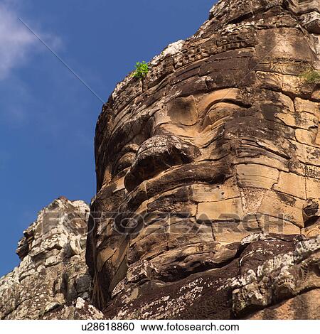Stock Image - Large Buddha statue at the Khmer Kingdom palace ruins. Fotosearch