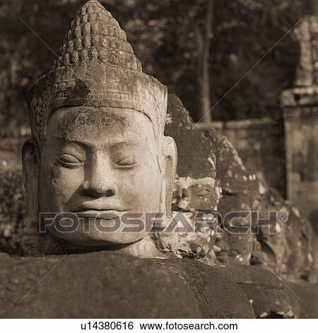 Stock Photograph - Large Buddha statue at the Khmer Kingdom palace ruins. Fotosearch