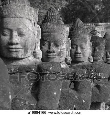 Stock Photograph - Large Buddha statues at the Khmer Kingdom palace ruins. Fotosearch