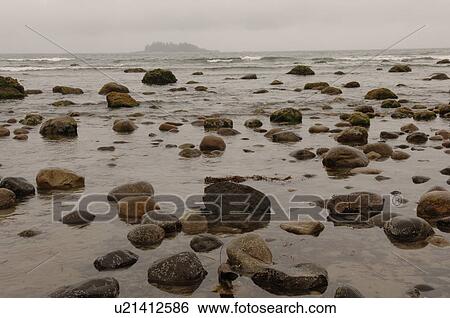 Stock Photograph - Beach on a cloudy day, Florencia Bay, Vancouver Island, Canada. Fotosearch
