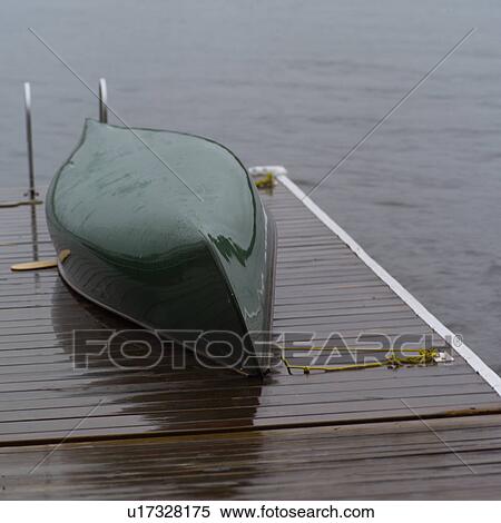 Stock Photography - A boat lying upside down on a pier. Fotosearch