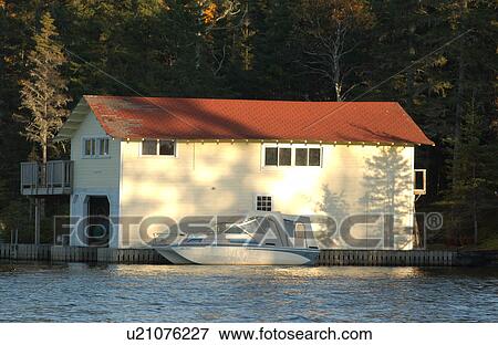 Stock Photo - Boathouse on Lake. Fotosearch