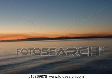 Stock Photography - Silhouette of shoreline against twilight sky. Fotosearch