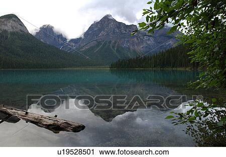 Stock Image - A lake between mountains, Rocky Mountains, Canada. Fotosearch