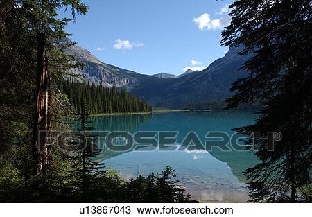 Lake surrounded by Rocky Mountains, Canada View Large Photo Image Stock Image - Lake surrounded by Rocky Mountains, Canada. Fotosearch