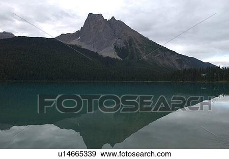 Stock Photo - Reflection of a mountain in a lake, Rocky Mountains, Canada. Fotosearch