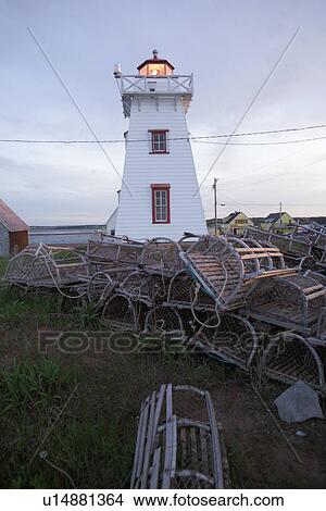 Lobster traps stacked in front of a light house in Prince Edward Island, Canada View Large Photo Image Picture - Lobster traps stacked in front of a light house in Prince Edward Island, Canada. Fotosearch