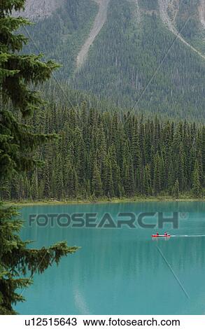 Stock Image - A lake between mountains, Rocky Mountains, Canada. Fotosearch