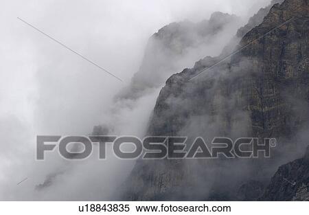 Stock Photography - Fog enveloping a mountain, Rocky Mountains, Canada. Fotosearch