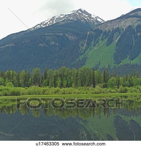 Stock Photography - Girl sitting by Kinney Lake, Mt. Robson Provincial Park, Canada. Fotosearch