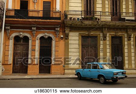 Stock Photography - A car parked in front of a building, Havana, Cuba. Fotosearch