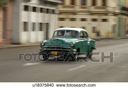 An antique car moving on a road, Havana, Cuba View Large Photo Image Stock Image - An antique car moving on a road, Havana, Cuba. Fotosearch