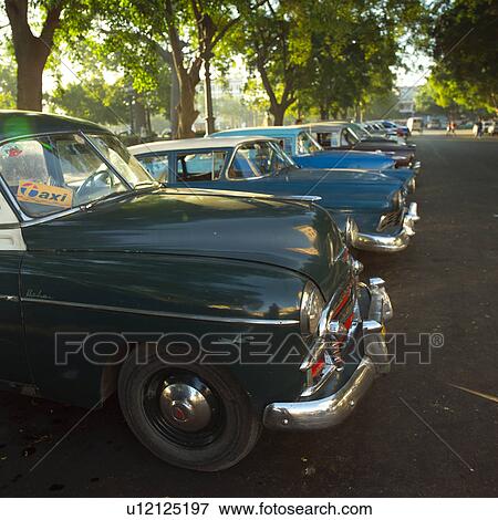Stock Photo - An array of parked antique taxi cabs, Havana, Cuba. Fotosearch