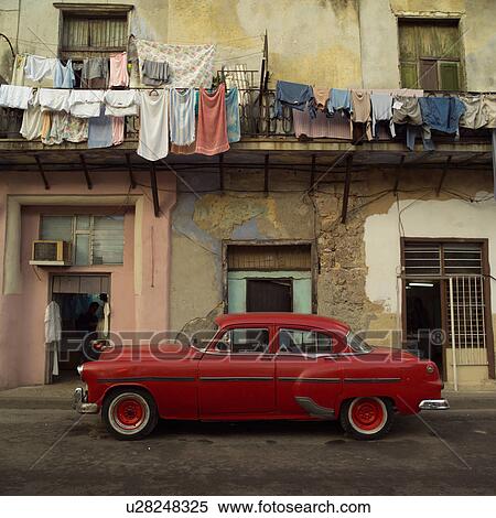Stock Photography - Antique car parked in front of a building, Havana, Cuba. Fotosearch