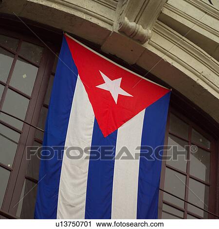 Low angle view of a flag hanging in front of a building, Havana, Cuba View Large Photo Image Stock Image - Low angle view of a flag hanging in front of a building, Havana, Cuba. Fotosearch