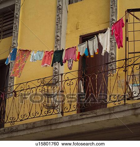 Low angle view of clothes hanging on a clothes line in a balcony, Havana, Cuba View Large Photo Image Stock Image - Low angle view of clothes hanging on a clothes line in a balcony, Havana, Cuba. Fotosearch